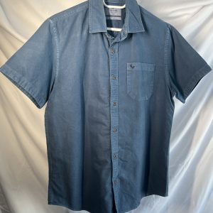 Front view of a blue short-sleeve button-up shirt hanging on a white hanger against a white background.